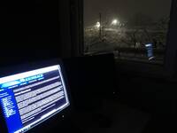 Razorback on a CRT monitor, positioned next to a window revealing the snow outside at night